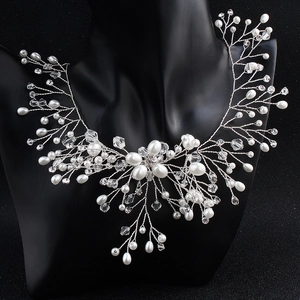 Detailed macro view of bridal necklace set with pearls and crystals on mannequin