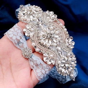 Luxurious light blue lace bridal garter with heavy hand-sewn rhinestones and pearls