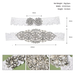 Close-up of bridal garter with hand-sewn rhinestones, pearls, and white floral lace
