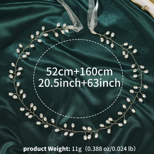 Detailed view of handmade bridal hair vine with pearls and gold wire on green silk