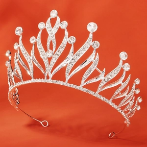 Baroque silver bridal crown with sparkling rhinestones on vibrant orange background