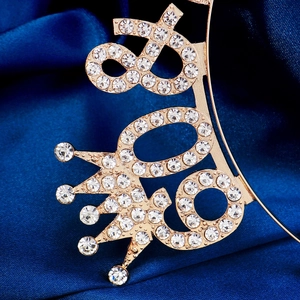 Macro shot of 30th birthday gold crown headband with sparkling crystal rhinestones