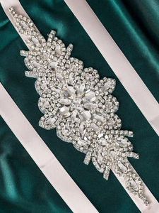 Detailed view of hand-stitched crystal bridal belt with marquise rhinestones on satin