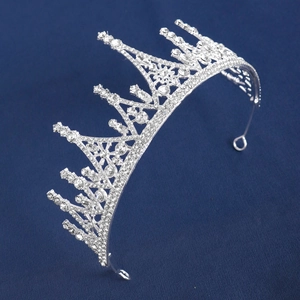 Elegant silver bridal crown with crystal rhinestones for weddings on navy fabric background