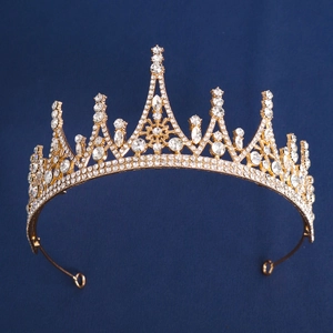 Detailed view of luxury gold crystal bridal crown with intricate vintage rhinestone patterns
