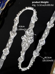 Macro shot of bridal sash with detailed hand-sewn rhinestones and pearls on white mesh