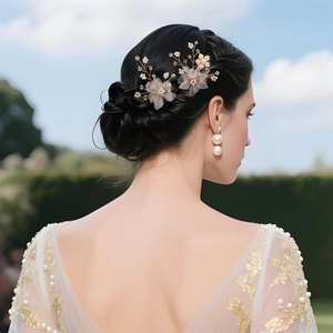 Detailed view of handmade bridal hair pins with tulle flowers and pearls on hair