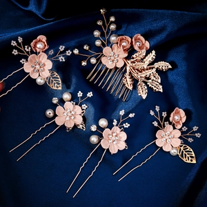 Pink floral bridal hair accessory set with pearls and rhinestones on blue silk background