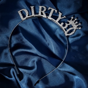Detail of silver birthday headband with Dirty 30 crystal lettering on blue satin