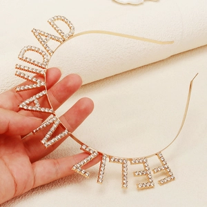 Macro shot of gold rhinestone headband featuring the Feliz Navidad festive greeting