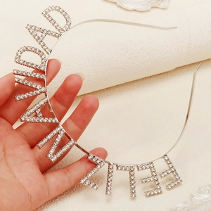Close-up of a silver Navidad headband featuring sparkling rhinestones on metal