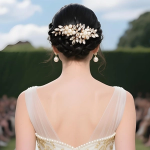 Close-up of elegant bridal hair comb set with pearls and crystals on a low bun hairstyle