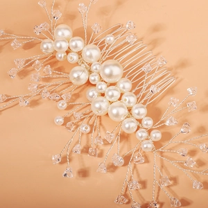 Detailed close-up of handmade bridal hair comb with pearls and crystal rhinestones