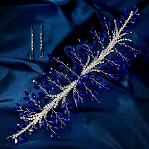 Detail of silver bridal hair vine with royal blue crystals on navy silk background