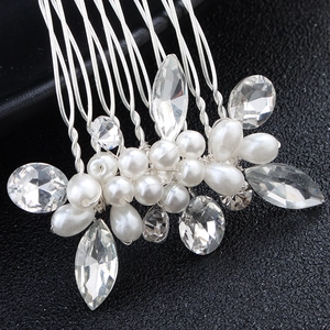 Detailed macro view of handmade bridal hair comb with pearls and marquise crystals