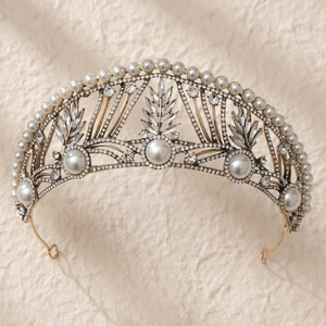 Detailed macro view of vintage gold bridal tiara with polished pearls and rhinestones