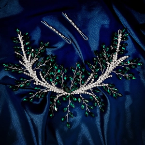 Detailed close-up of handmade bridal headband with emerald green gems and rhinestones