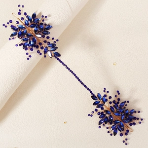 Détails de strass en cristal bleu roi et fils dorés sur un peigne de mariée