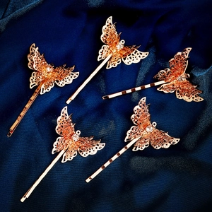 Five-piece golden hollow butterfly hair clips with zircon on blue silk backdrop