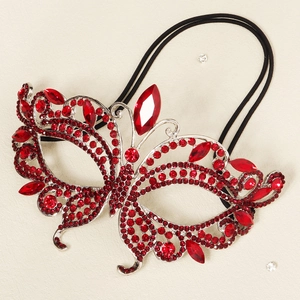 Detail of red rhinestone butterfly mask showing intricate crystals and faceted stones