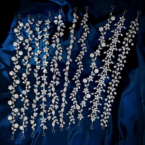 Detail von funkelnden Braut-Haarranken mit silbernen Blumenmustern auf blauem Seide