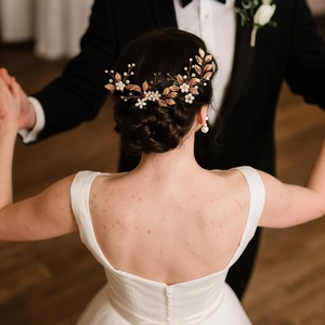 Detail of rose gold bridal hairpiece with hand-woven leaves, pearls and matching earrings