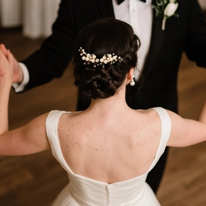 Detailed view of handmade pearl and crystal bridal hair comb with elegant gold wire weaving