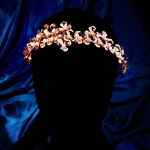 Close-up of golden metal flower headband with white pearls for bridal hair styling
