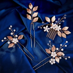 Detailed view of handmade rose gold leaf hair pins and comb set with white pearls
