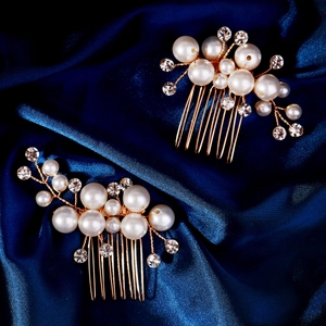 Detailed close-up of handmade bridal hair comb with pearls and rhinestones on blue silk