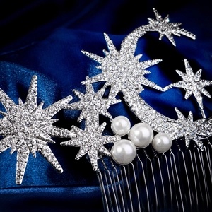 Macro shot of celestial hair comb featuring moon and star shapes with inlaid rhinestones
