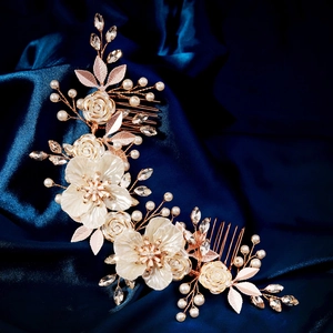 Detailed bridal hair comb with white acrylic flowers and pearls on blue silk background