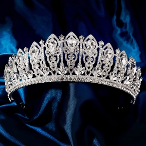 Detail of luxury bridal crown featuring sparkling crystal rhinestones on a silk background