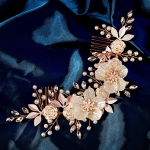 Detailed close-up of handmade white acrylic flower bridal hair comb with pearls and crystals