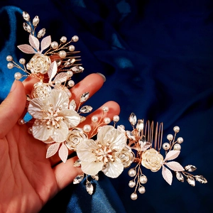 Handmade bridal hair comb with white acrylic flowers, pearls and crystals on blue fabric