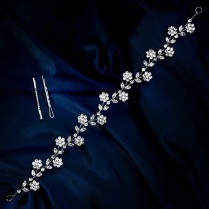 Detailaufnahme des Braut-Haarbandes mit silbernen Strassblumen auf dunkelblauem Satin