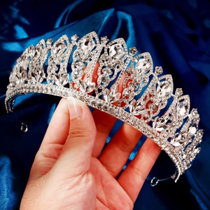 Luxurious silver crown for bridal weddings featuring sparkling rhinestones on blue silk