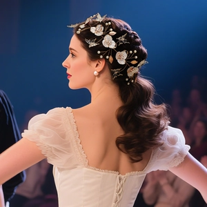 Detail of bridal headband with acrylic petals, pearls and golden butterflies on model