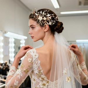 Detail of bridal headband with handmade resin flowers, pearls and gold leaves