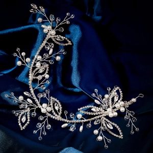 Detail of handmade silver bridal hair vine with pearls and crystals on blue silk