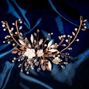 Handmade bridal headband with white resin flowers and pearls on golden wire weave