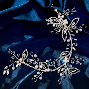 Elegant bridal hair vine with silver wire, white pearls, and sparkling crystals on satin