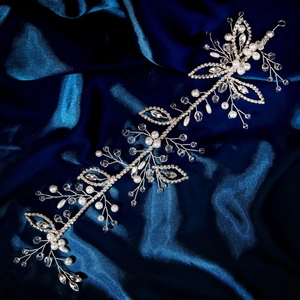 Detailed macro of handmade silver bridal headband with pearls and crystals on silk