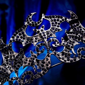 Macro shot of gothic bat crown featuring dark blue rhinestones and moon details