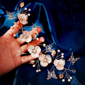Handmade bridal hair vine with white resin flowers, acrylic butterflies and gold leaves