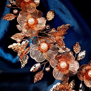 Close-up of golden floral bridal headpiece with butterfly motifs and sparkling crystals