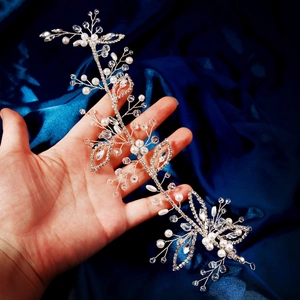 Elegant silver bridal headband with pearls, crystals, and rhinestones on blue silk