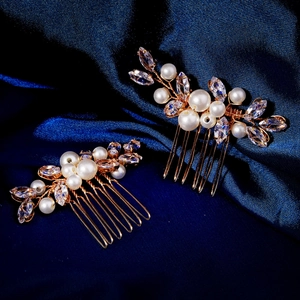 Detail of handmade bridal hair combs with white pearls and marquise crystals on gold alloy