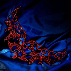 Gothic black metal crown featuring intricate filigree with ruby red rhinestones