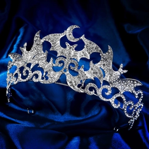 Macro view of silver gothic tiara with intricate bat wings and moon rhinestone details